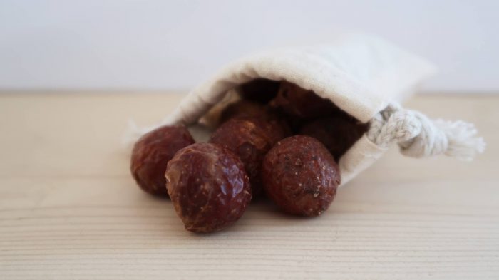 The image is of soap nuts. They are hard, dried brown berries that look wrinkled.